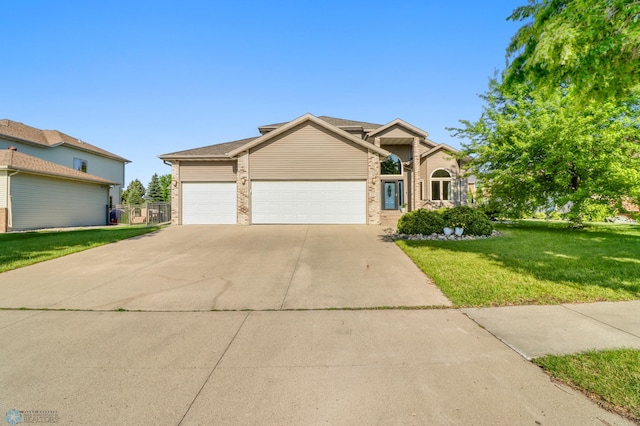 4375 58th St S, Fargo, ND 58104 - traditional home with concrete driveway, a garage, and brick siding