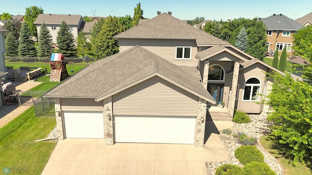 4375 58th St S, Fargo, ND 58104 - traditional-style house with an attached garage, brick siding, concrete driveway, and a shingled roof