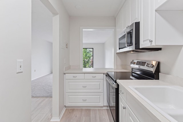 4100 Parklawn Ave Unit 118, Edina, MN 55435 - kitchen with appliances with stainless steel finishes, white cabinets, light countertops, and light wood finished floors