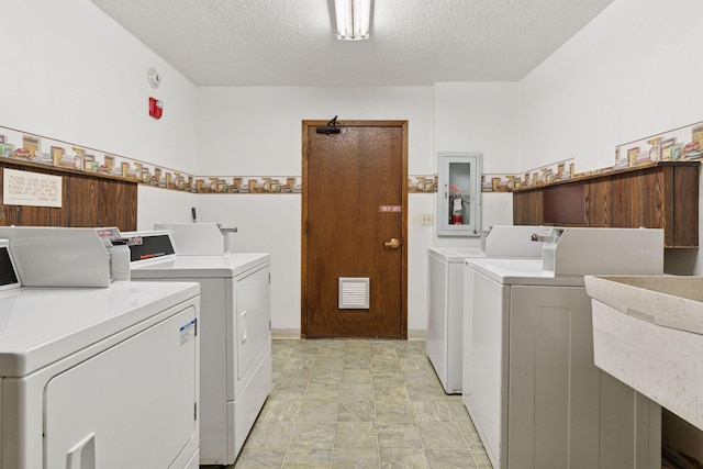 4100 Parklawn Ave Unit 118, Edina, MN 55435 - community laundry room featuring separate washer and dryer, a textured ceiling, and stone finish floors