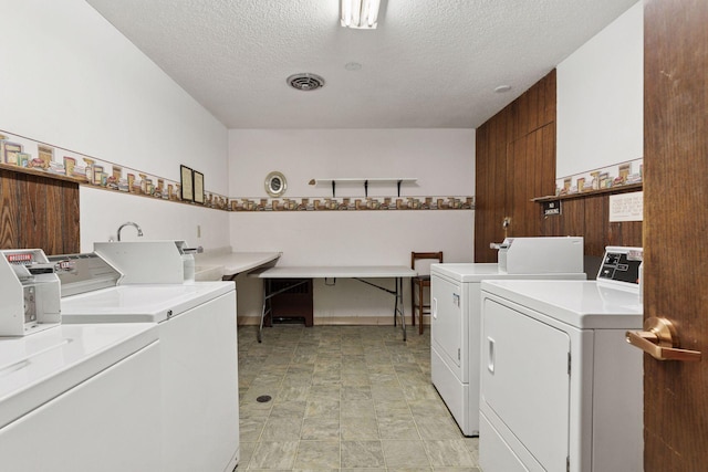 4100 Parklawn Ave Unit 118, Edina, MN 55435 - community laundry featuring washer and dryer, a textured ceiling, and stone finish floors