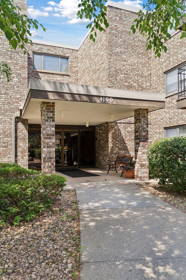 4100 Parklawn Ave Unit 118, Edina, MN 55435 - view of front of home featuring brick siding, driveway, and a carport