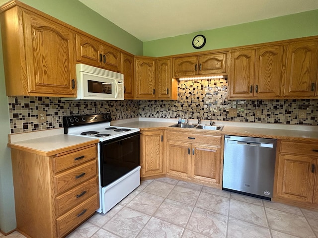 402 6th St NE, Barnesville, MN 56514 - kitchen with stainless steel dishwasher, electric stove, white microwave, and backsplash