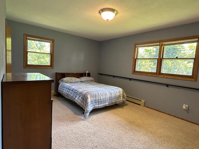 402 6th St NE, Barnesville, MN 56514 - carpeted bedroom with multiple windows and a baseboard heating unit