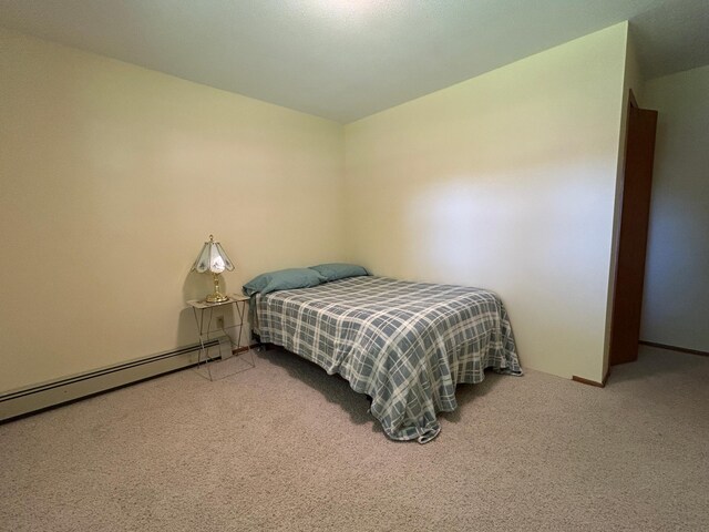 402 6th St NE, Barnesville, MN 56514 - bedroom featuring carpet floors and a baseboard radiator
