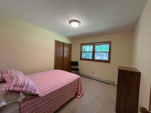 402 6th St NE, Barnesville, MN 56514 - bedroom with a baseboard radiator, carpet, and a closet