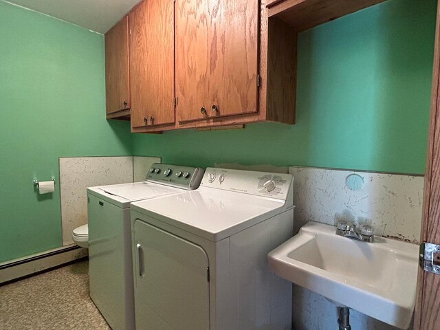 402 6th St NE, Barnesville, MN 56514 - washroom featuring baseboard heating and separate washer and dryer