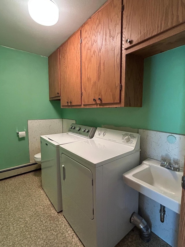 402 6th St NE, Barnesville, MN 56514 - laundry area featuring washer and dryer, cabinet space, and a baseboard radiator