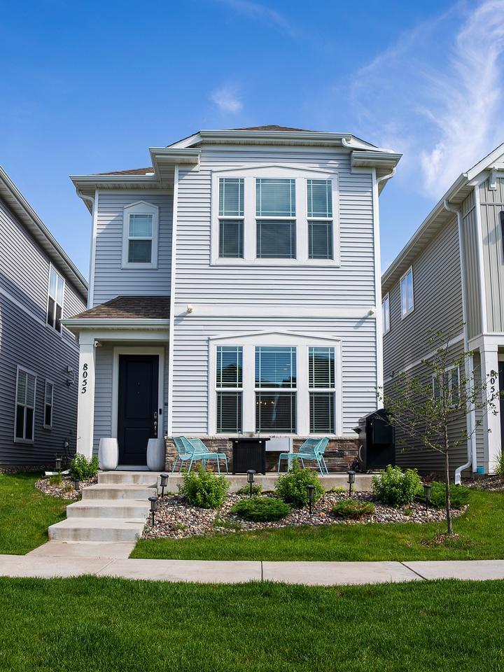 8055 Arrowwood Ln N, Maple Grove, MN 55369 - view of front of home featuring a patio area and a front lawn
