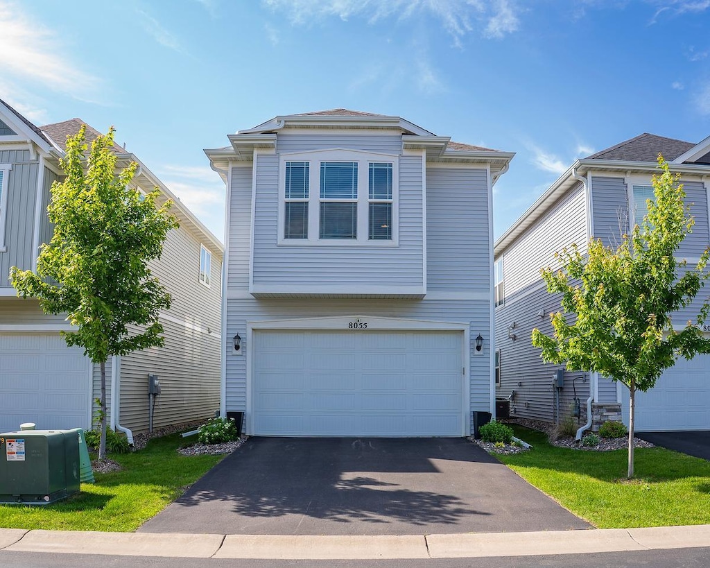 8055 Arrowwood Ln N, Maple Grove, MN 55369 - view of front facade featuring an attached garage and asphalt driveway