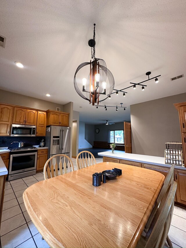 405 Fir Ave, Frazee, MN 56544 - dining room with a chandelier, light tile patterned floors, a ceiling fan, recessed lighting, and track lighting