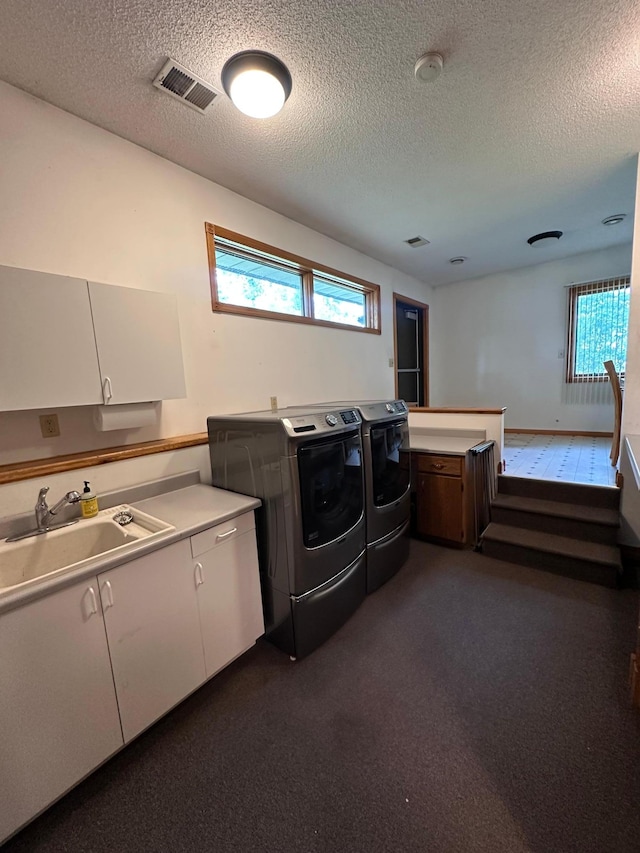 405 Fir Ave, Frazee, MN 56544 - laundry room featuring separate washer and dryer, cabinet space, healthy amount of natural light, and a textured ceiling