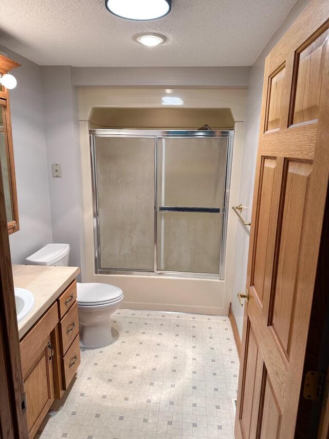 405 Fir Ave, Frazee, MN 56544 - bathroom with vanity, a textured ceiling, shower / bath combination with glass door, and tile patterned floors