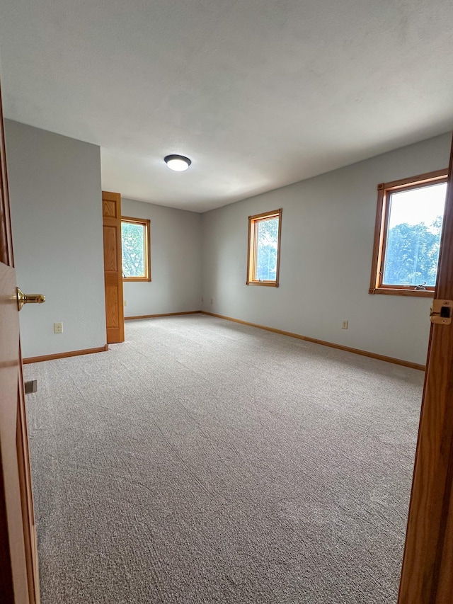 405 Fir Ave, Frazee, MN 56544 - unfurnished room featuring baseboards and light colored carpet