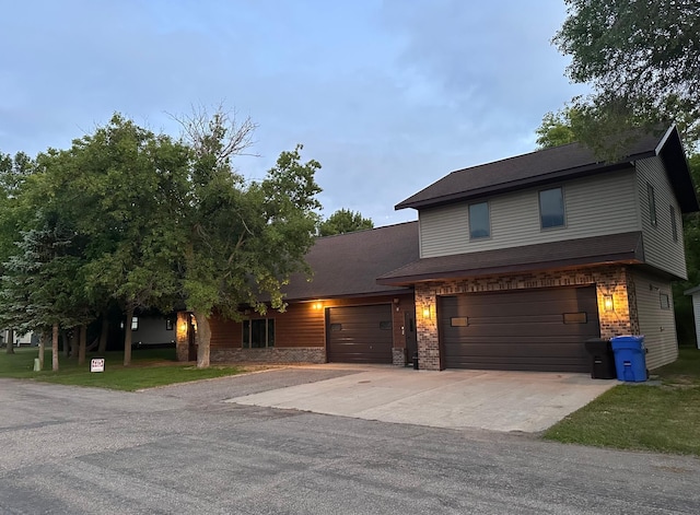 405 Fir Ave, Frazee, MN 56544 - view of front of home featuring driveway, brick siding, roof with shingles, and an attached garage