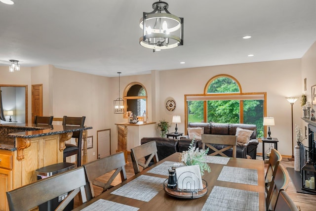 26943 140th St NW, Zimmerman, MN 55398 - dining space with a chandelier, wood finished floors, recessed lighting, and a fireplace