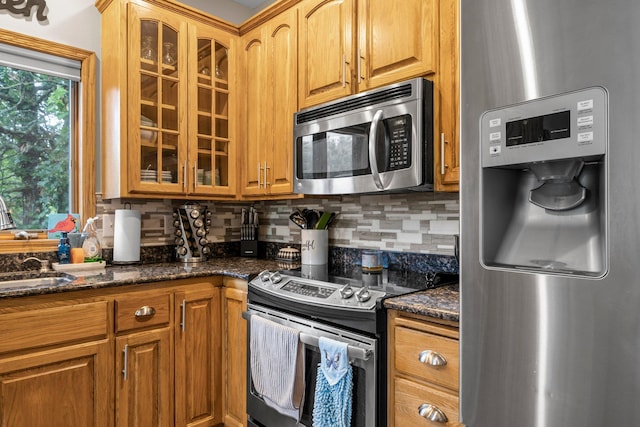 26943 140th St NW, Zimmerman, MN 55398 - kitchen with appliances with stainless steel finishes, glass insert cabinets, and decorative backsplash