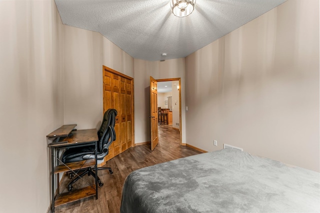 26943 140th St NW, Zimmerman, MN 55398 - bedroom featuring wood finished floors, a textured ceiling, and an office area