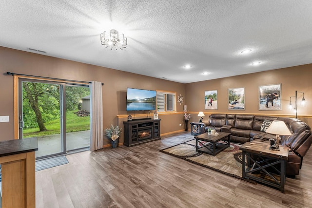 26943 140th St NW, Zimmerman, MN 55398 - living area with a textured ceiling, wood finished floors, recessed lighting, and a chandelier