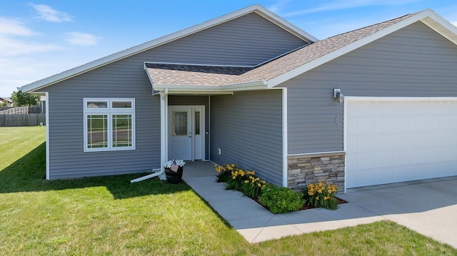 307 Brussels Ct, Marshall, MN 56258 - view of front of house featuring a garage, a shingled roof, a front yard, and stone siding