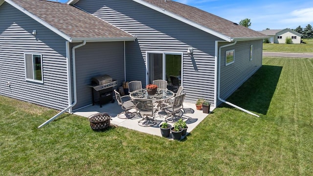307 Brussels Ct, Marshall, MN 56258 - back of house with a patio area, a lawn, and a shingled roof