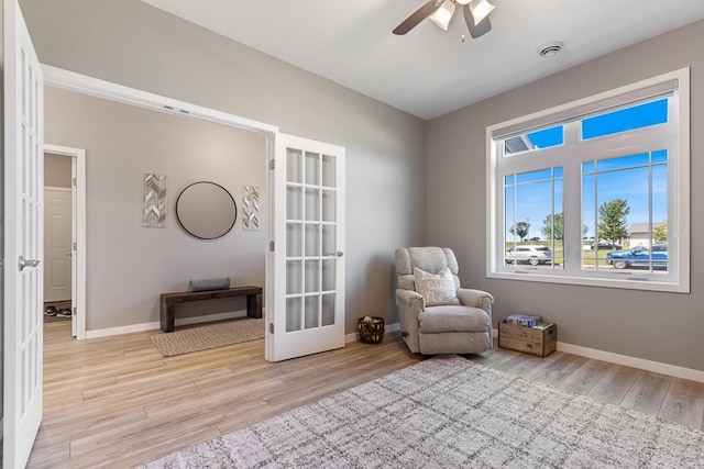 307 Brussels Ct, Marshall, MN 56258 - sitting room featuring light wood-style floors, a ceiling fan, and french doors