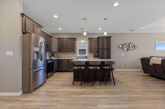 307 Brussels Ct, Marshall, MN 56258 - kitchen with stainless steel fridge with ice dispenser, range with electric cooktop, light countertops, open floor plan, and recessed lighting