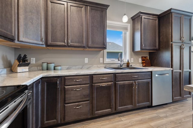 307 Brussels Ct, Marshall, MN 56258 - kitchen featuring dark brown cabinets, black range with electric cooktop, light wood-style flooring, pendant lighting, and light stone countertops