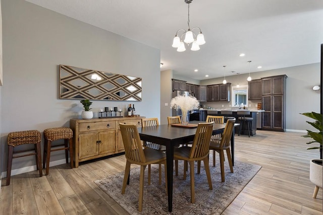 307 Brussels Ct, Marshall, MN 56258 - dining room with a chandelier, light wood-style floors, and recessed lighting