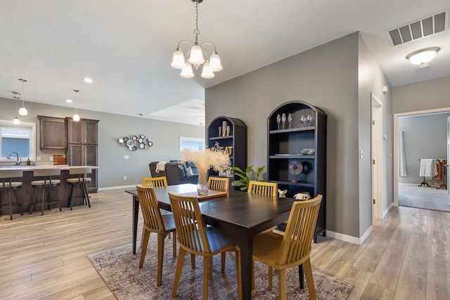 307 Brussels Ct, Marshall, MN 56258 - dining space featuring light wood-type flooring, a chandelier, plenty of natural light, and recessed lighting