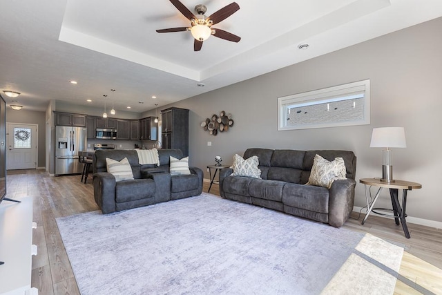 307 Brussels Ct, Marshall, MN 56258 - living area with ceiling fan, healthy amount of natural light, a raised ceiling, light wood-style flooring, and recessed lighting