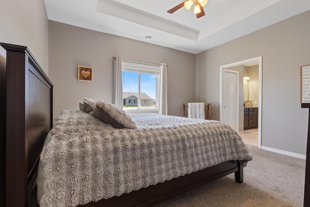307 Brussels Ct, Marshall, MN 56258 - bedroom featuring light carpet, a tray ceiling, ceiling fan, and ensuite bathroom