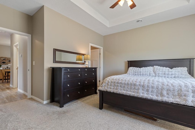 307 Brussels Ct, Marshall, MN 56258 - carpeted bedroom featuring ceiling fan and a tray ceiling