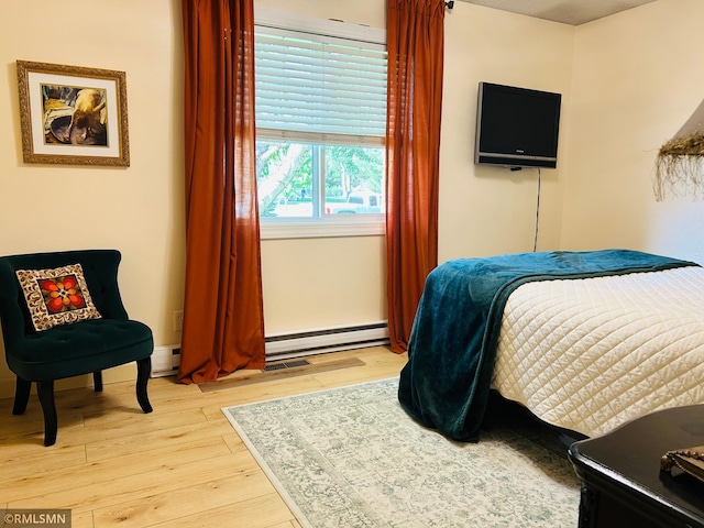 1904 Parkview Rd NE, Alexandria, MN 56308 - bedroom featuring light wood-style flooring and a baseboard heating unit