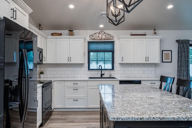 101 Butterfly Ct, Blue Earth, MN 56013 - kitchen featuring black appliances, white cabinetry, backsplash, and recessed lighting