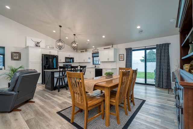 101 Butterfly Ct, Blue Earth, MN 56013 - dining area featuring vaulted ceiling, a chandelier, light wood-type flooring, and recessed lighting