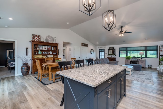 101 Butterfly Ct, Blue Earth, MN 56013 - kitchen with a ceiling fan, a chandelier, lofted ceiling, open floor plan, and a center island