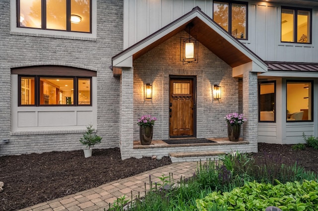5705 Covington Cir, Minnetonka, MN 55345 - property entrance featuring board and batten siding, brick siding, and a standing seam roof