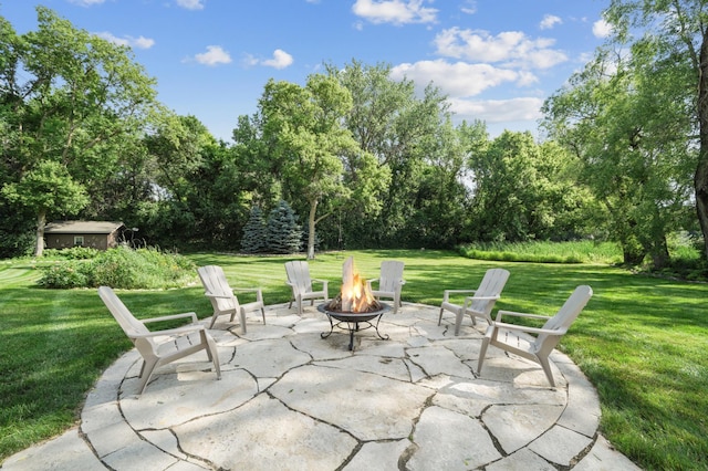 5705 Covington Cir, Minnetonka, MN 55345 - view of patio / terrace with a fire pit and view of wooded area