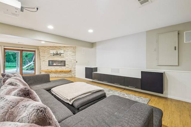 5705 Covington Cir, Minnetonka, MN 55345 - living area with wood finished floors, a large fireplace, a wainscoted wall, and recessed lighting