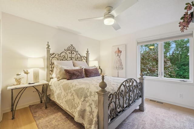 5705 Covington Cir, Minnetonka, MN 55345 - bedroom featuring a ceiling fan, a textured ceiling, and wood finished floors