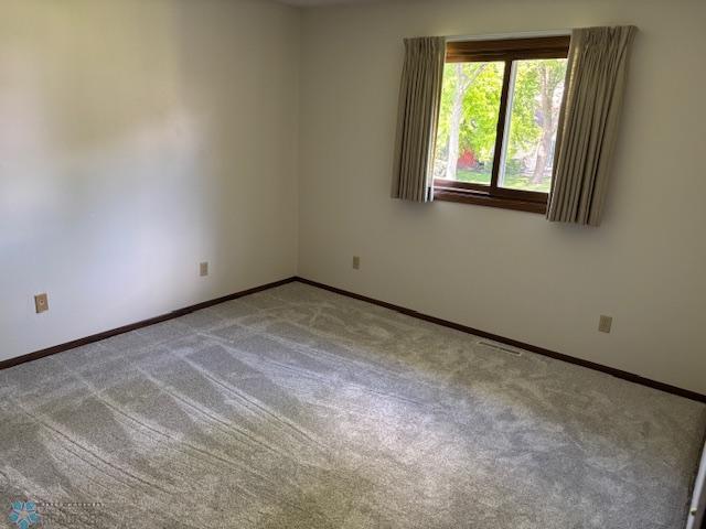 3818 Rivershore Dr, Moorhead, MN 56560 - carpeted spare room featuring baseboards
