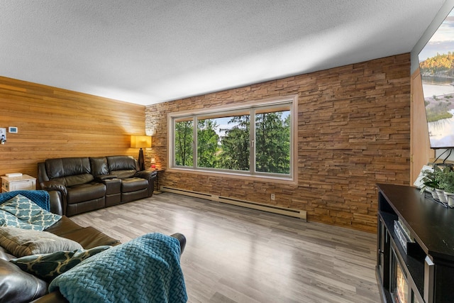 32873 Flanders St NE, Cambridge, MN 55008 - living area featuring a baseboard heating unit, wood walls, wood finished floors, and a textured ceiling