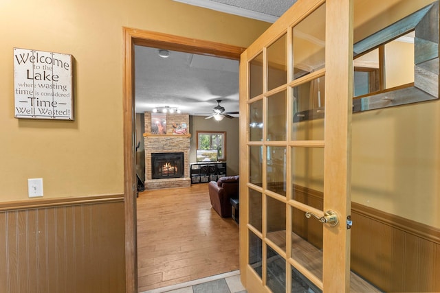 32873 Flanders St NE, Cambridge, MN 55008 - hallway featuring a wainscoted wall, wood finished floors, and a textured ceiling