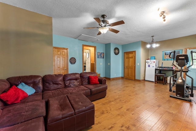 32873 Flanders St NE, Cambridge, MN 55008 - living area featuring light wood-style floors, a textured ceiling, ceiling fan, and a chandelier