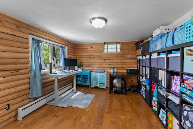 32873 Flanders St NE, Cambridge, MN 55008 - office area featuring rustic walls, a textured ceiling, wood-type flooring, and baseboard heating