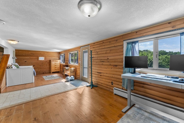 32873 Flanders St NE, Cambridge, MN 55008 - office featuring a textured ceiling, hardwood / wood-style flooring, a baseboard radiator, and log walls
