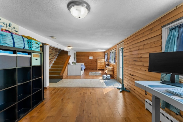 32873 Flanders St NE, Cambridge, MN 55008 - unfurnished living room with a textured ceiling, hardwood / wood-style flooring, log walls, and stairs