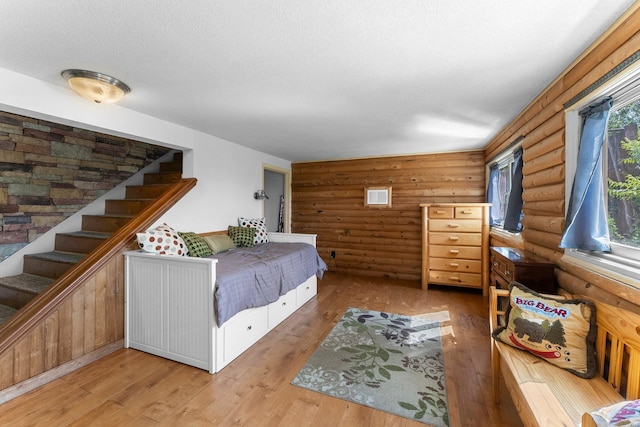 32873 Flanders St NE, Cambridge, MN 55008 - bedroom with rustic walls and hardwood / wood-style flooring