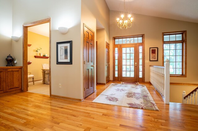 8980 160th Ln NW, Ramsey, MN 55303 - entrance foyer featuring a chandelier, light wood-style floors, and high vaulted ceiling